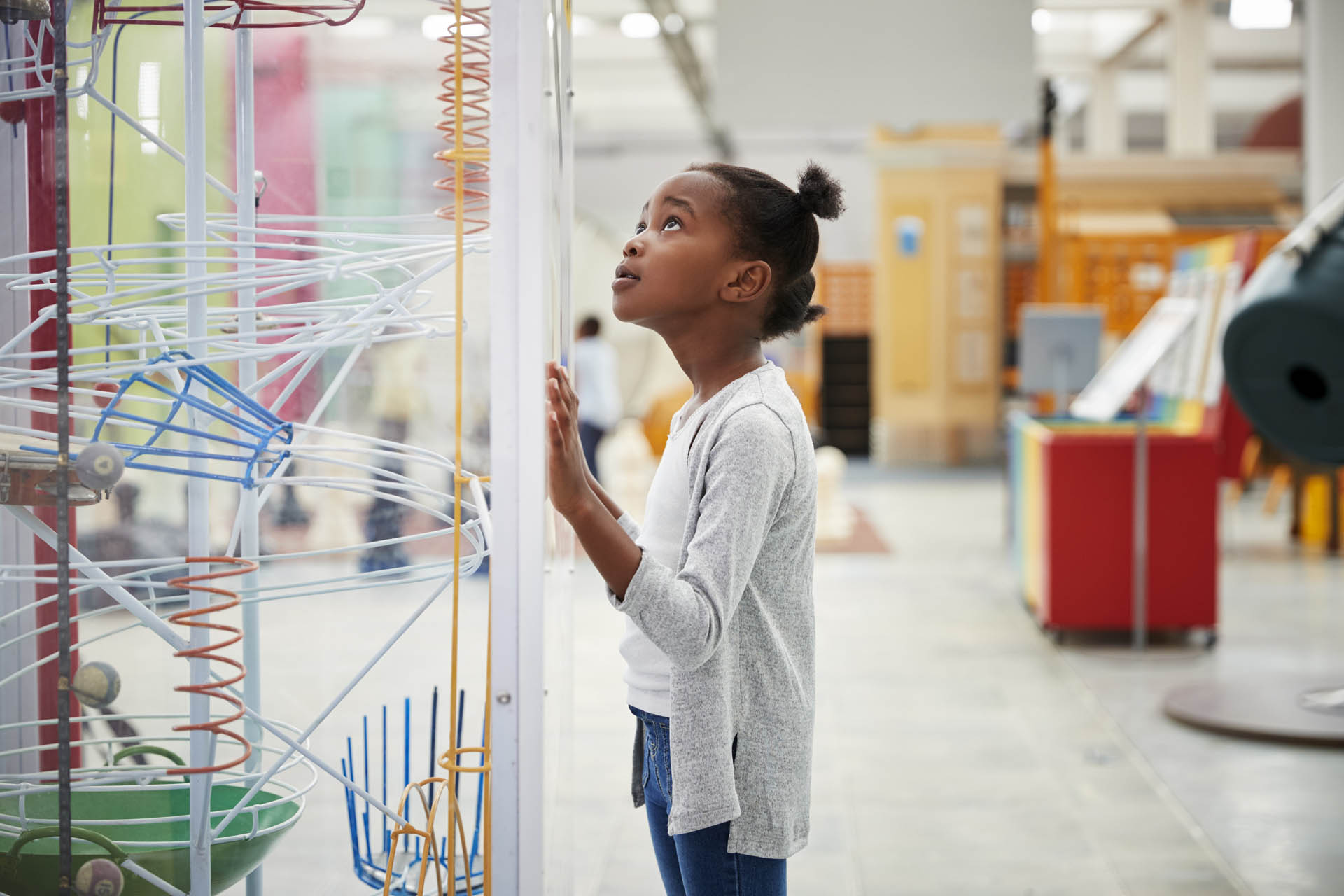 Young black girl looking at a science exhibit, close up - Unique Ideas for Spring Break in Orlando