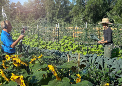 Spectrum 13 reporting standing in produce field with Farmer Nicole