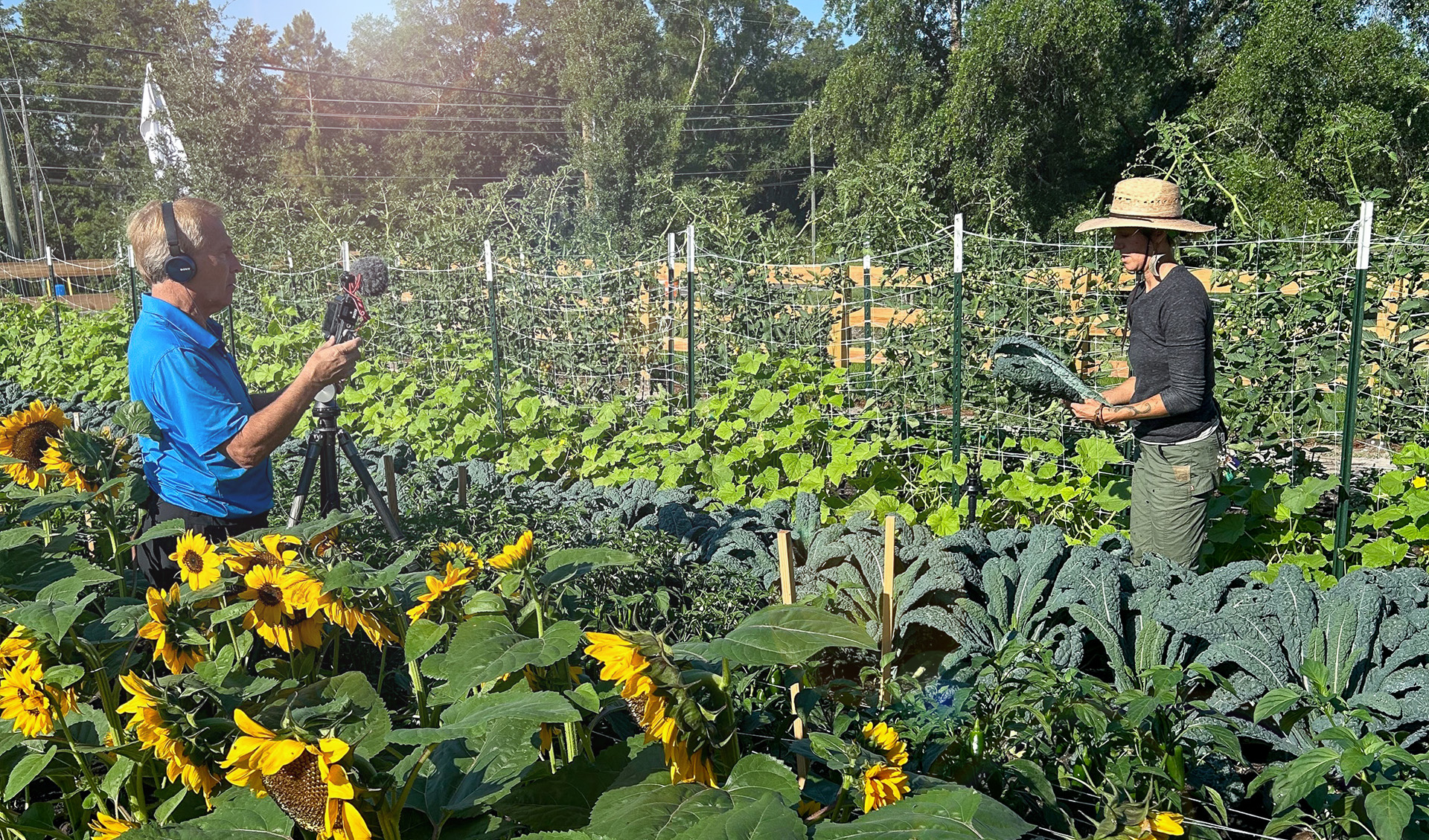 The Grow-Spectrum 13 Spot Spectrum 13 reporting standing in produce field with Farmer Nicole