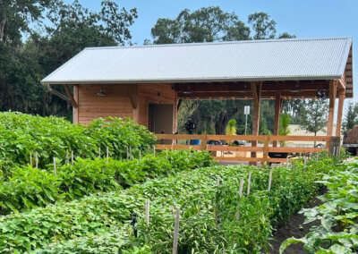 Demonstration farm at The Grow in Orlando with rows of crops and a wooden pavilion structure